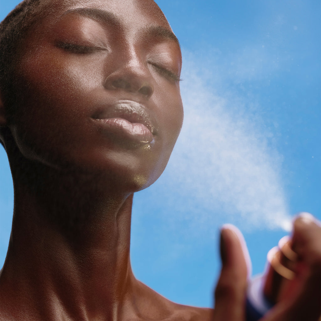 Woman Spraying The Face Mist