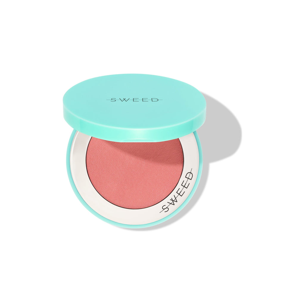 Compact blush with a mint green lid on a white background.