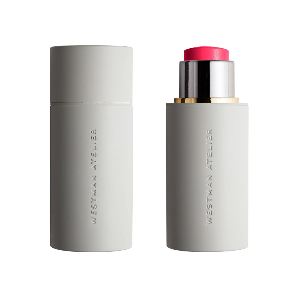 A Westman Atelier Baby Cheeks Blush Stick partially open to show its pink product with buildable color, against a white background.