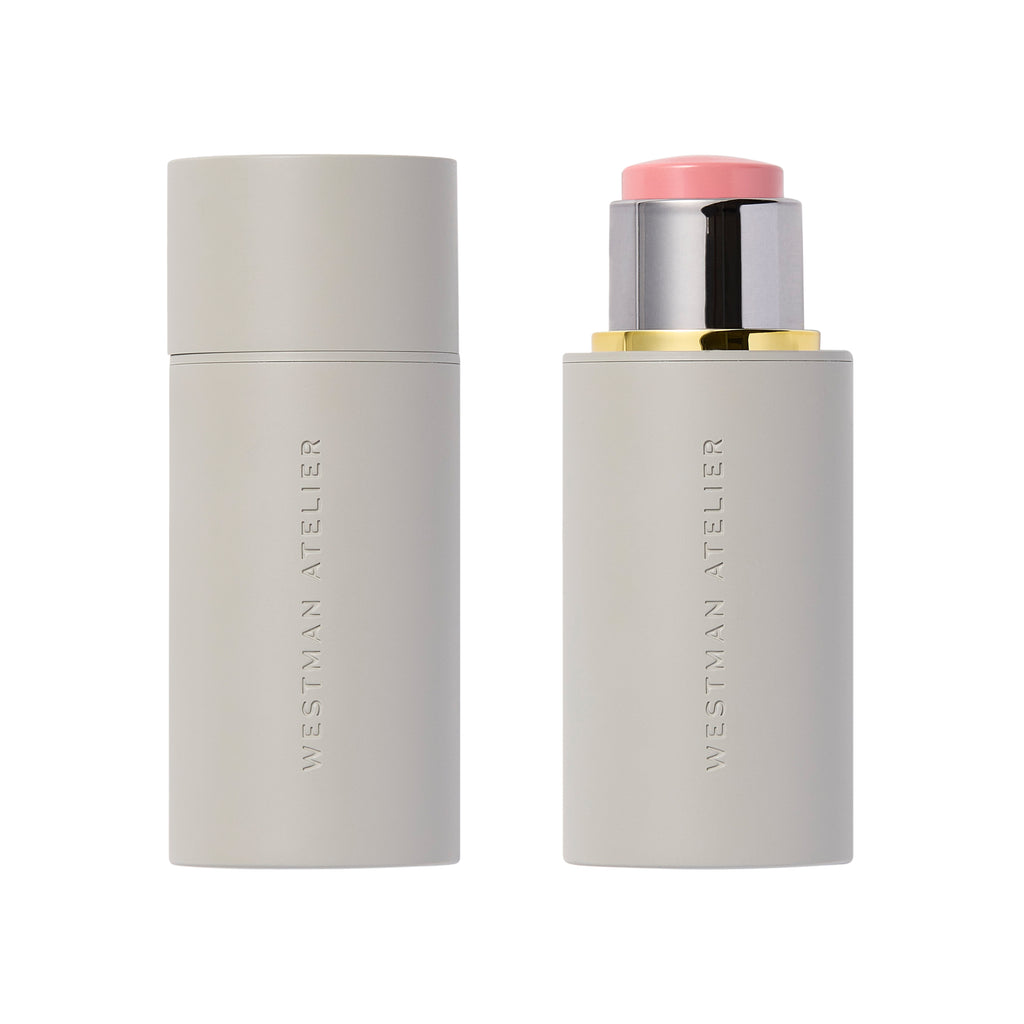 Two Westman Atelier Baby Cheeks Blush Sticks, one capped and the other open showing a pink-toned product with buildable color.