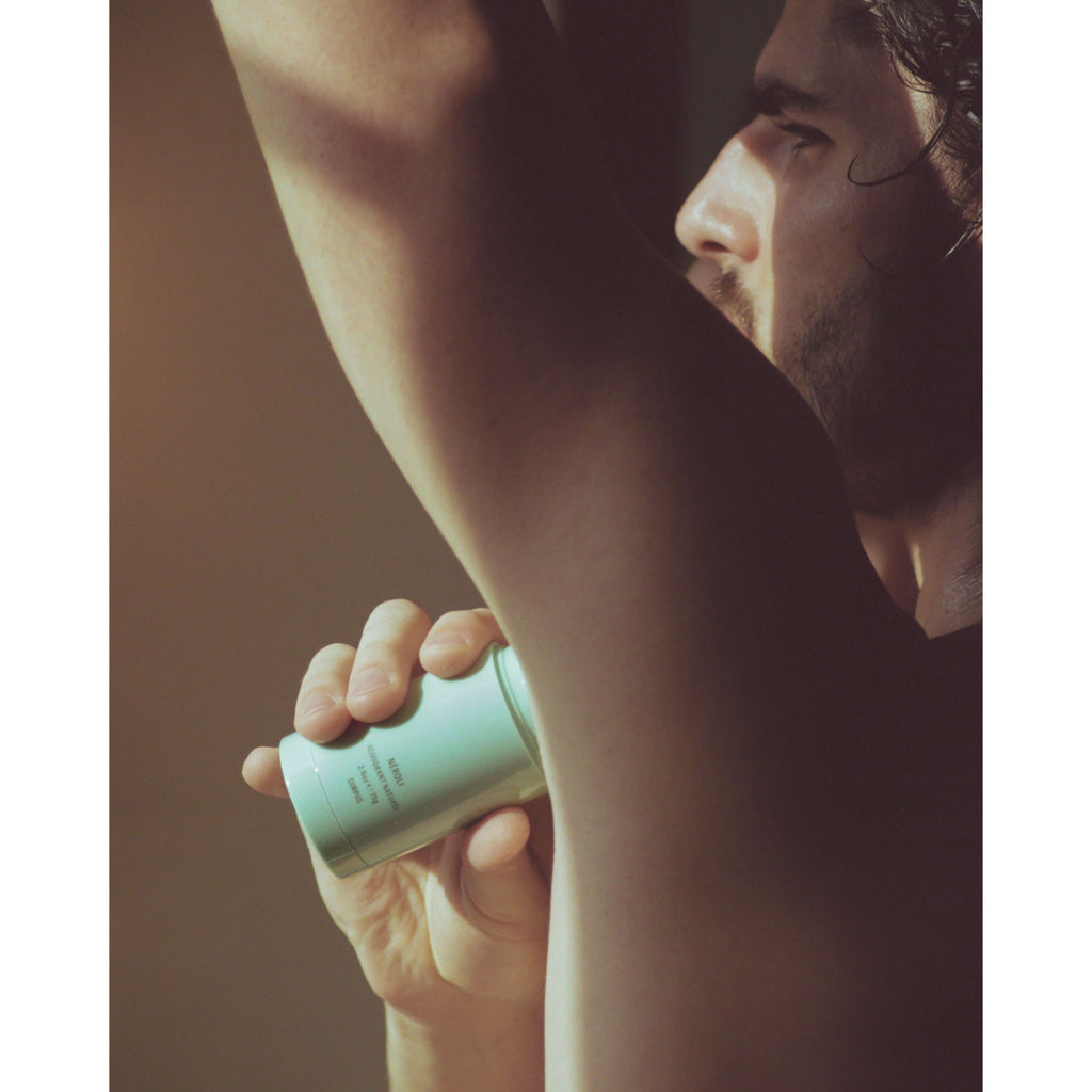 Male model applying Corpus deodorant