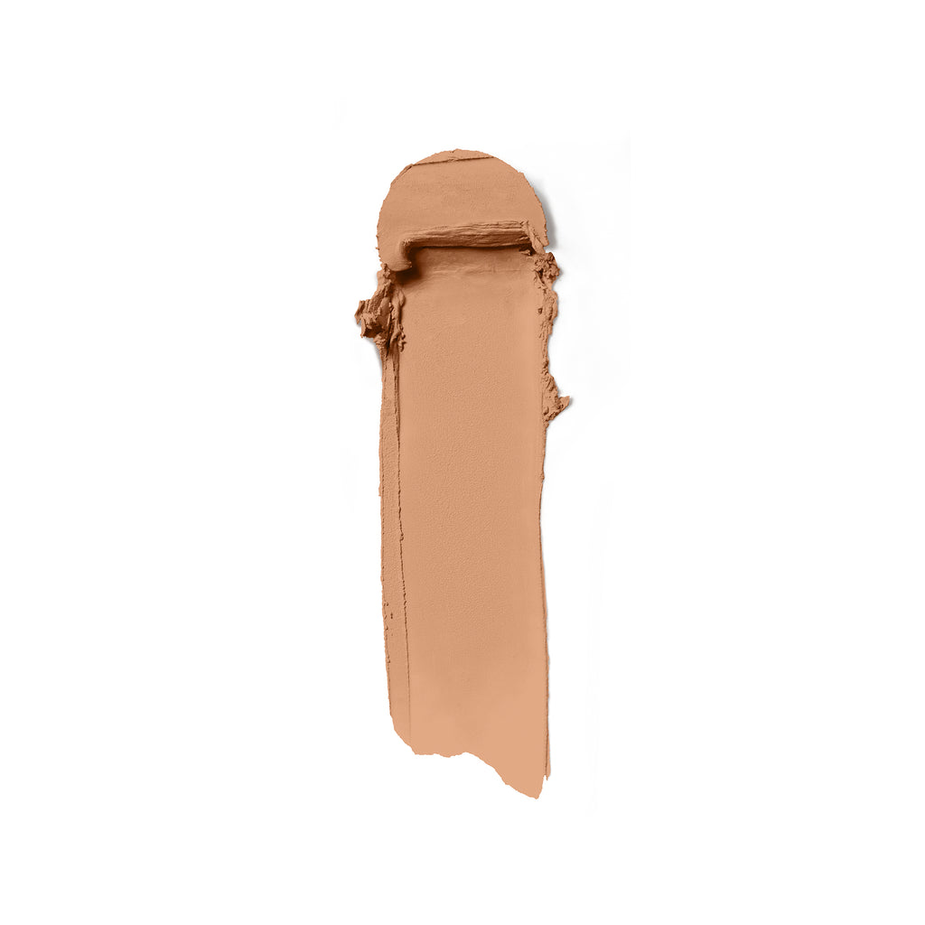 A smear of beige liquid foundation cosmetics on a white background.