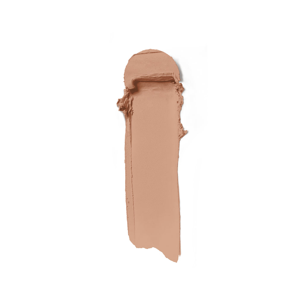 A swatch of beige liquid foundation makeup smeared on a white background.