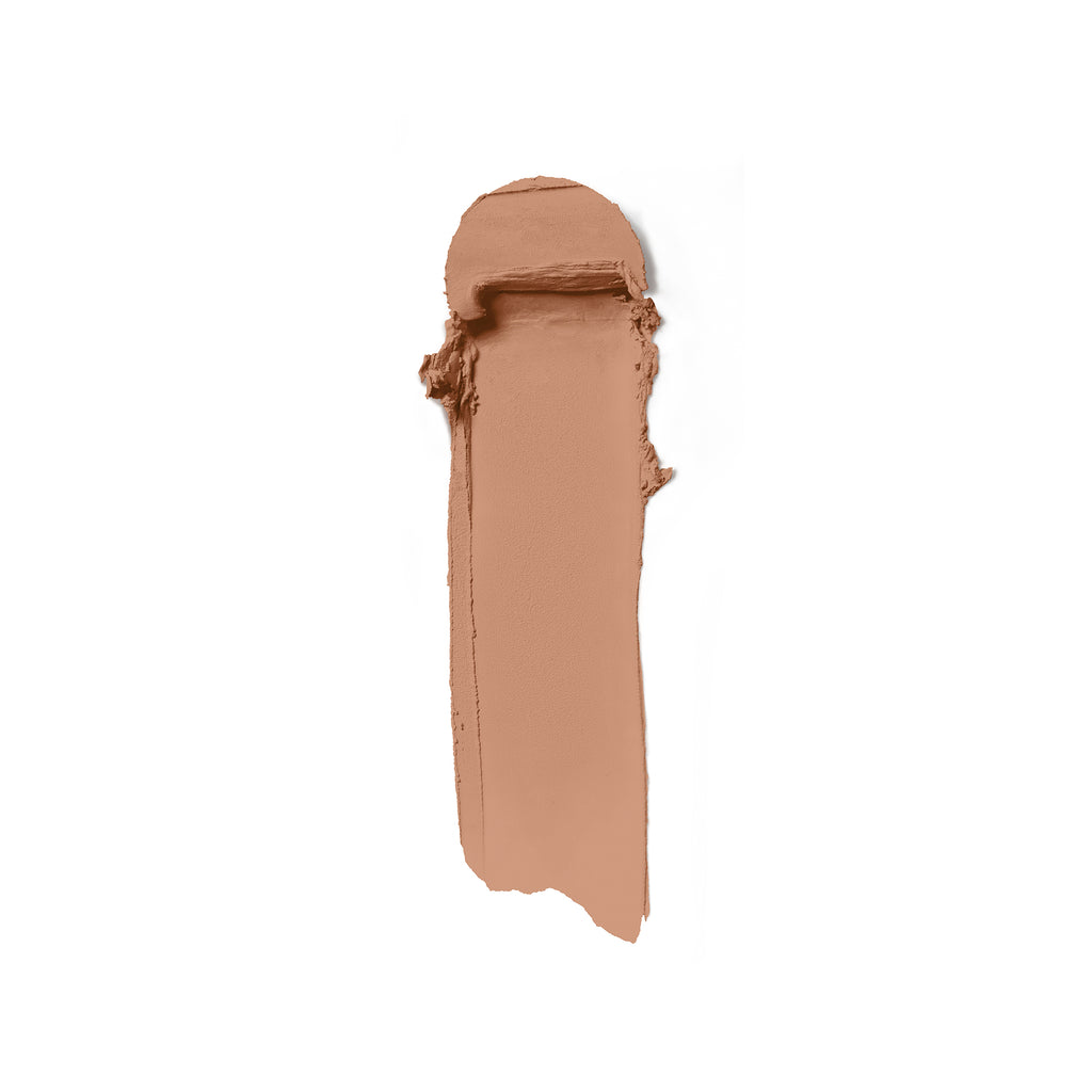 Smear of creamy beige makeup foundation on a white background.
