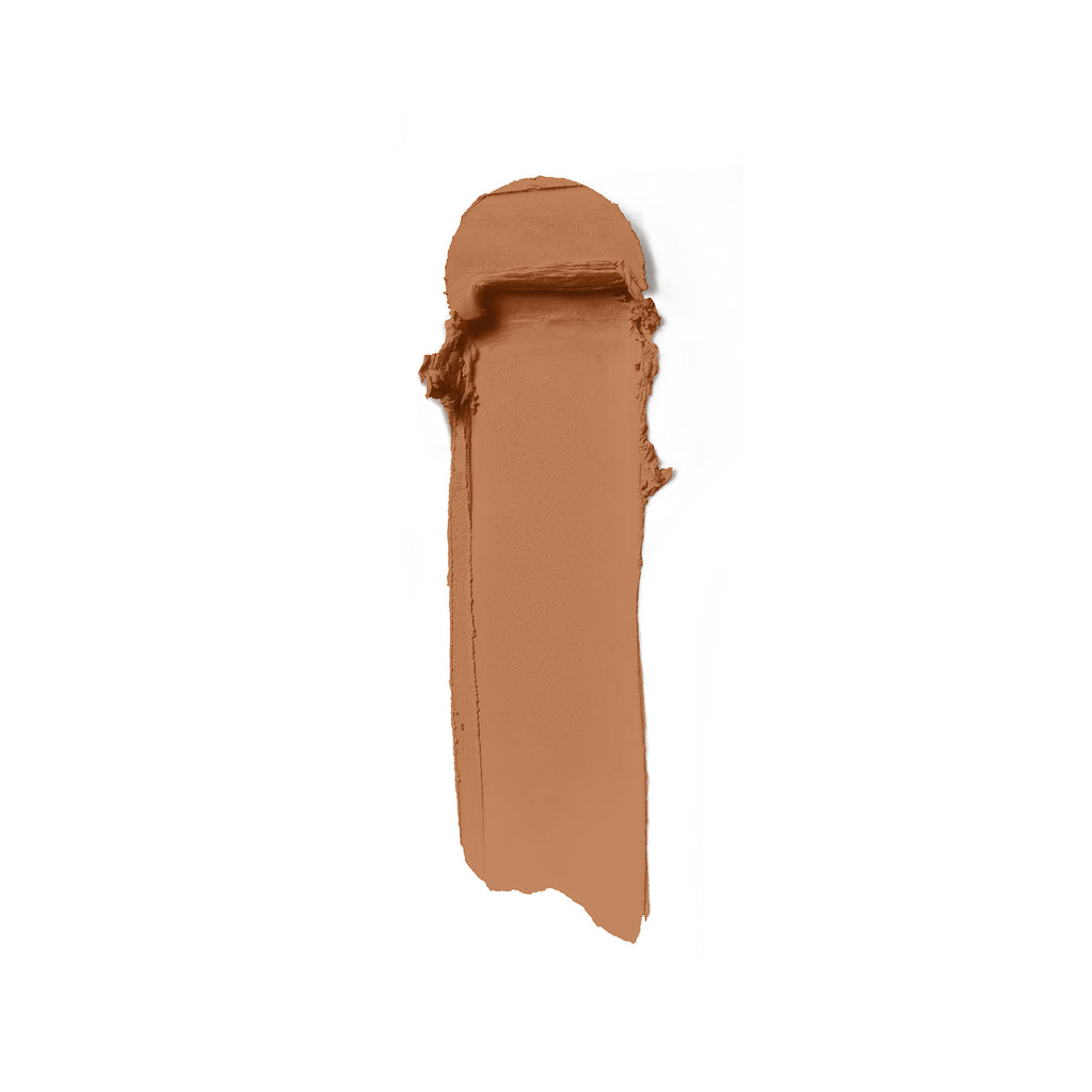 A smudge of brown makeup foundation on a white background.