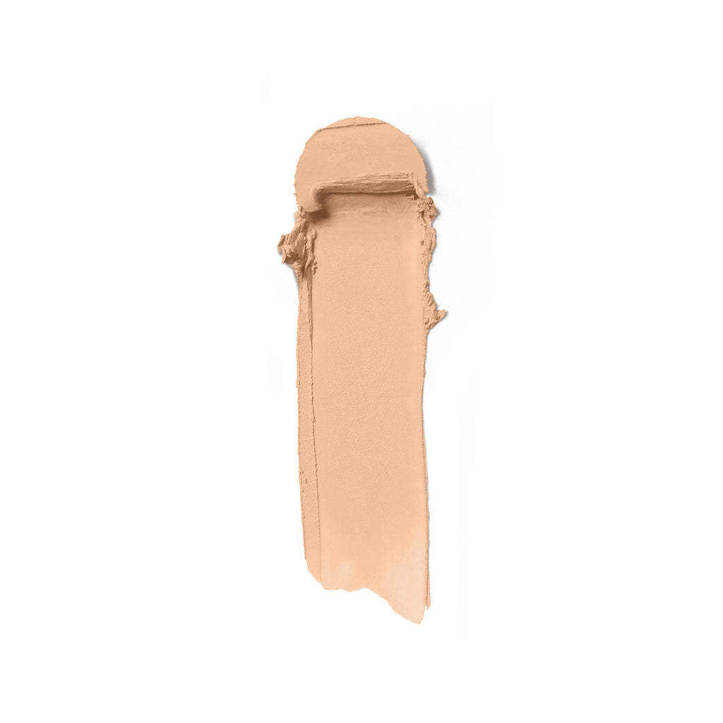 A swatch of beige liquid foundation makeup smeared on a white background.