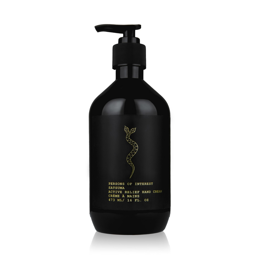 Black bottle with pump labeled "Person's of Interest Active Relief Hand Cream," featuring a gold snake design, isolated on a white background. This moisturizing hand cream is designed for dry hands.