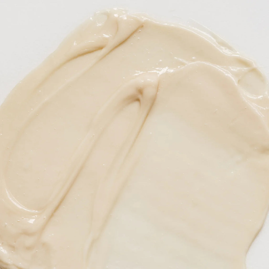 A swatch of liquid foundation makeup on a plain background.