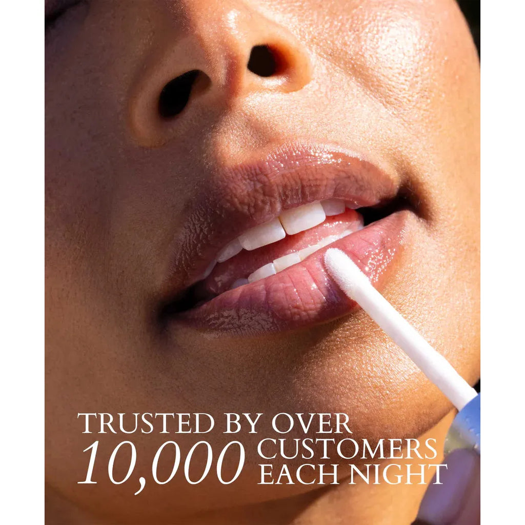 Close-up of a person applying lip gloss with a text overlay about customer trust.