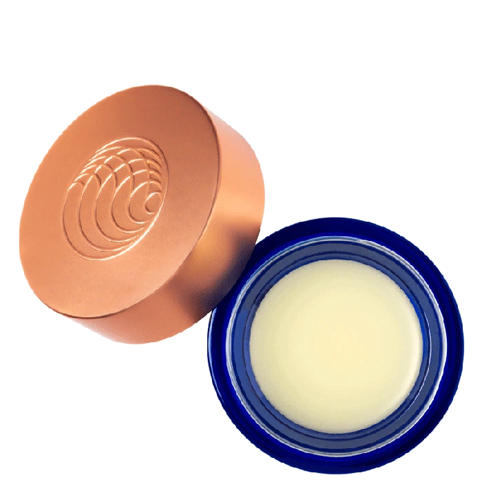 A jar of cosmetic cream with its lid placed beside it.