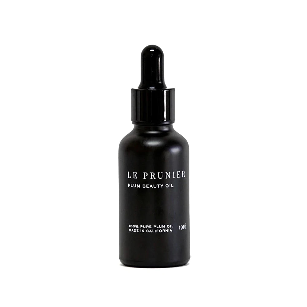 Black dropper bottle of le prunier plum beauty oil against a white background.
