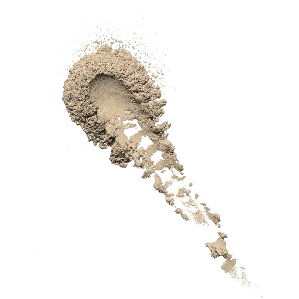 A pile of loose powder scattered on a white background.