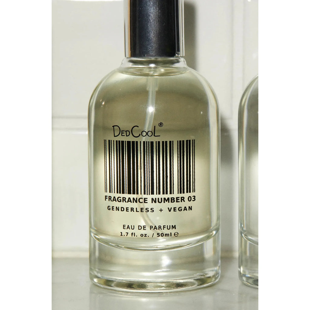 A bottle of dedcool fragrance number 03, which is labeled as genderless and vegan eau de parfum.