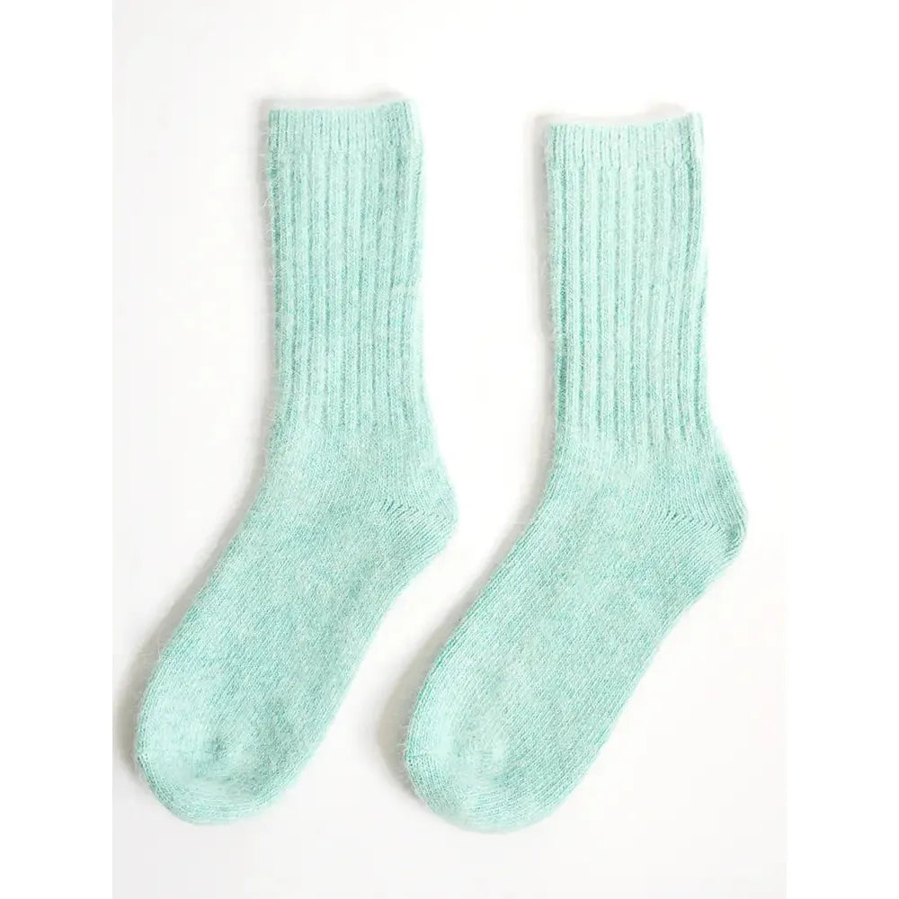 A pair of pastel green crew socks displayed on a white background.