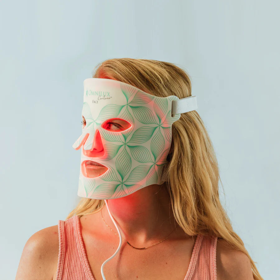 Woman wearing a led light therapy mask for skincare treatment.