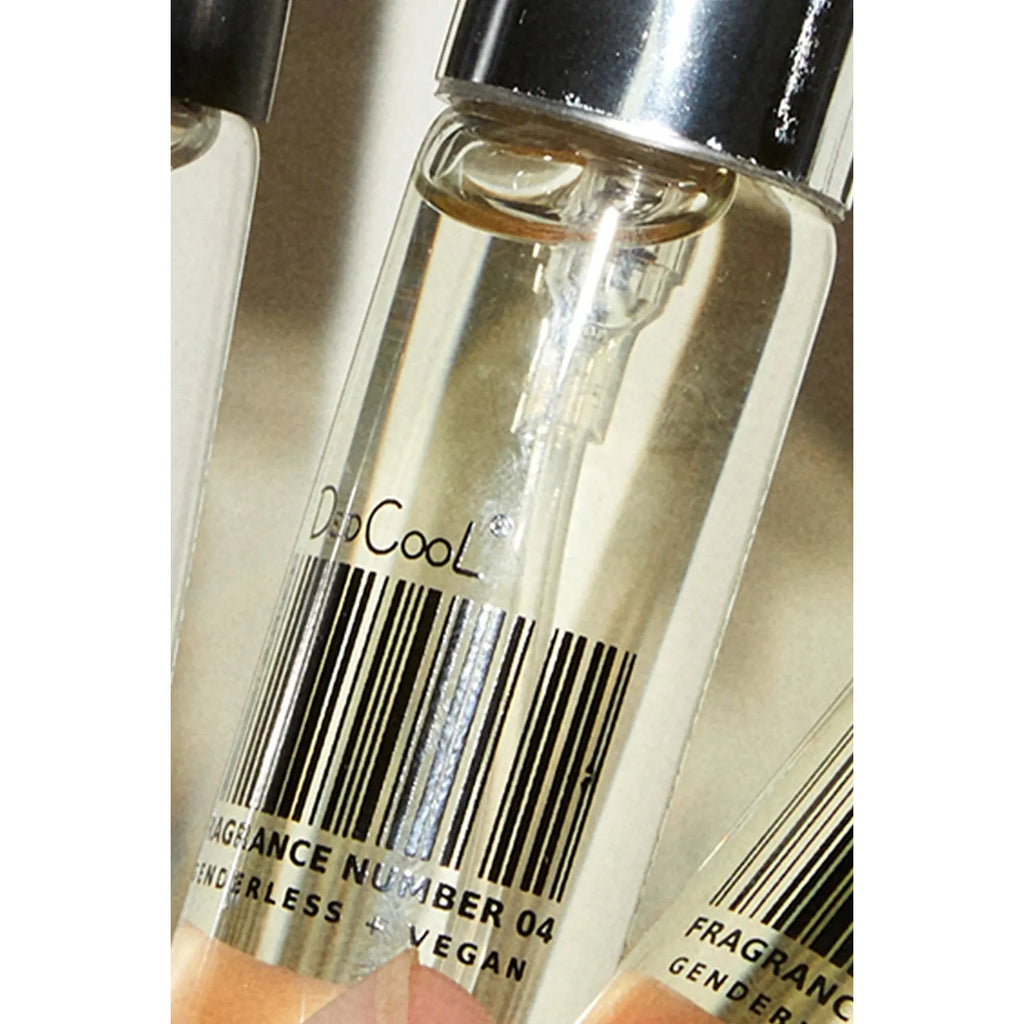 Close-up of vials with "dp cool" branding, labeled as "fragrance number 04" and "cruelty-free vegan.