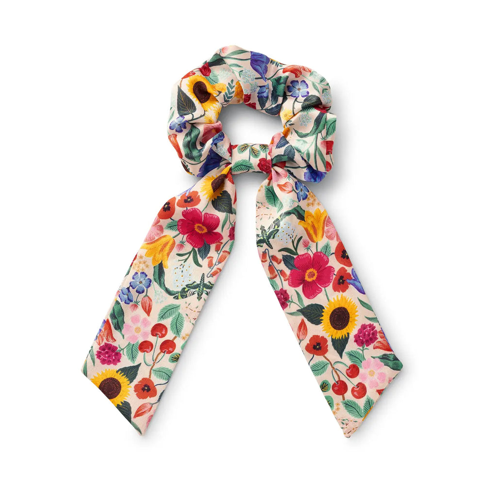 Colorful floral print scarf tied in a knot on a white background.