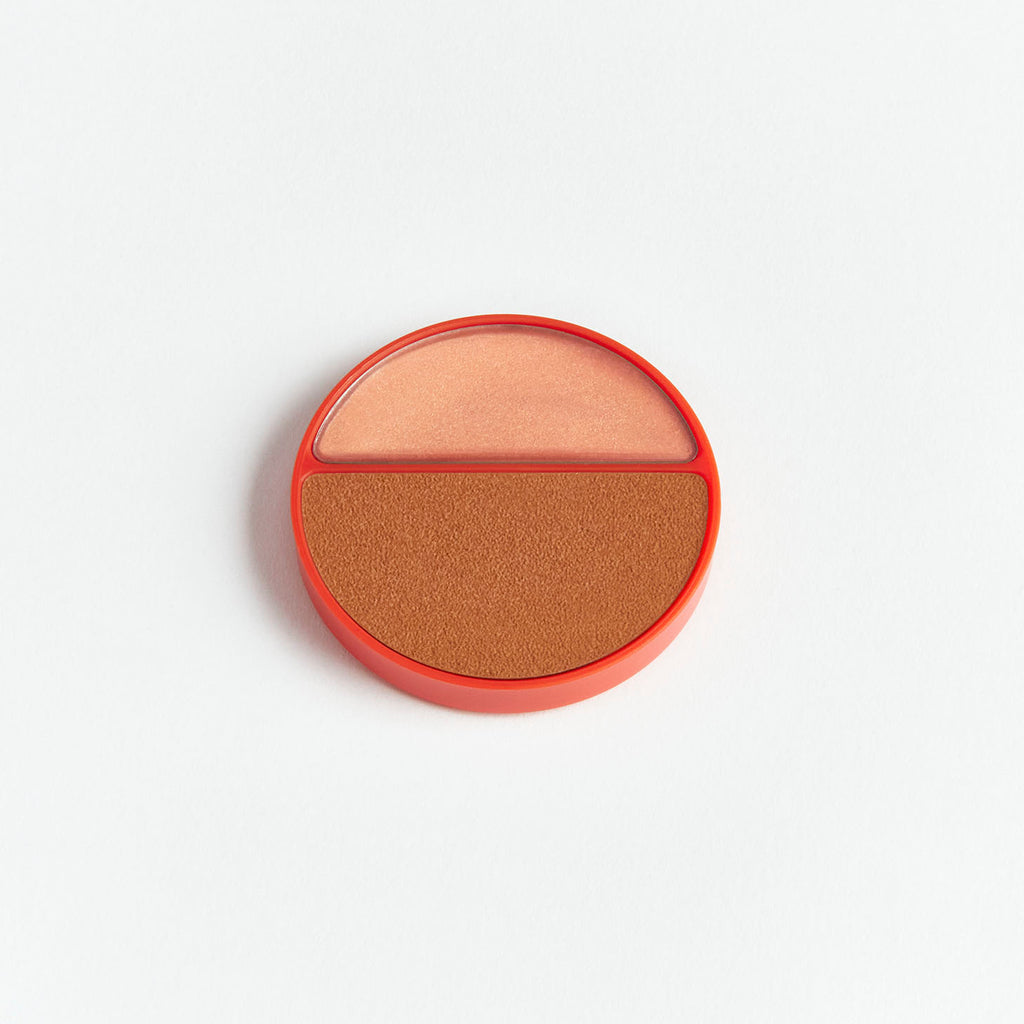 A dual-shade round blush compact on a white background.