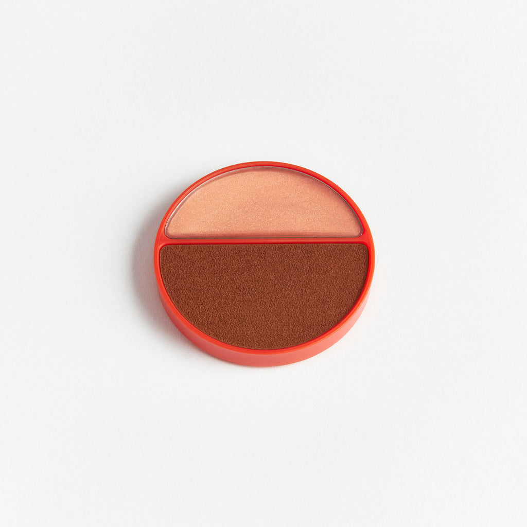 Dual-tone powder compact on a white background.