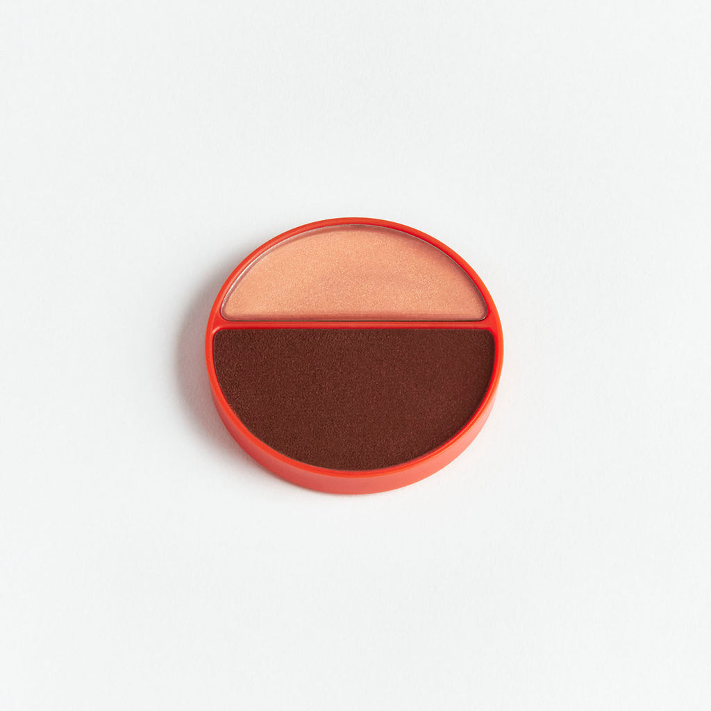 Round compact with dual-toned blush on a white background.