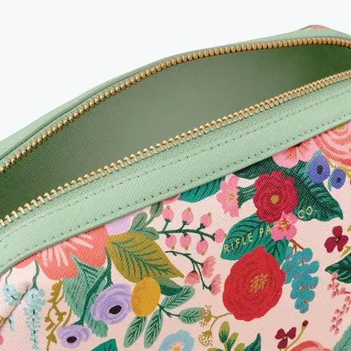 Close-up of a floral patterned fabric with a green zipper.