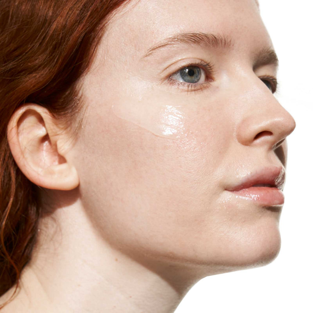 Close-up of a woman's face showcasing her skincare routine with a highlight on moisturized, healthy-looking skin.