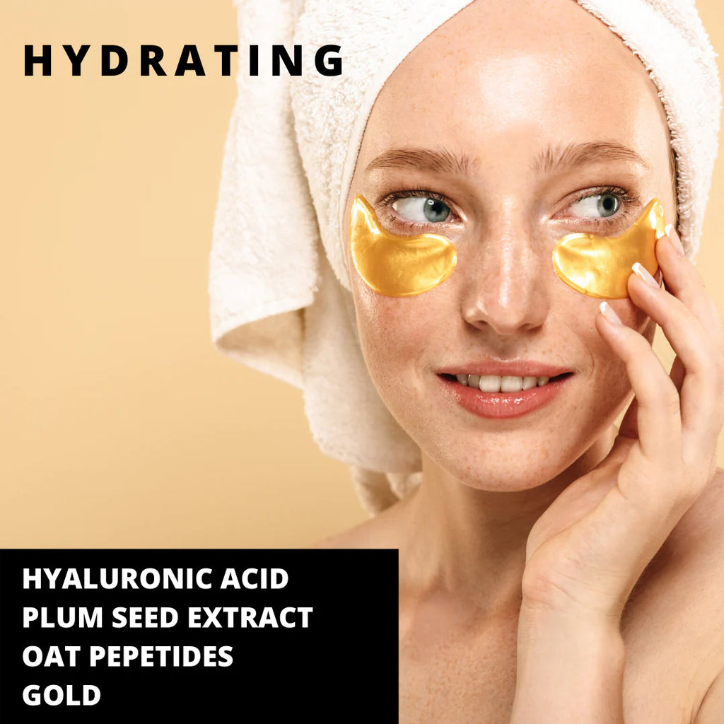Woman with a towel on her head applying gold under-eye patches, advertising hydrating skincare ingredients.