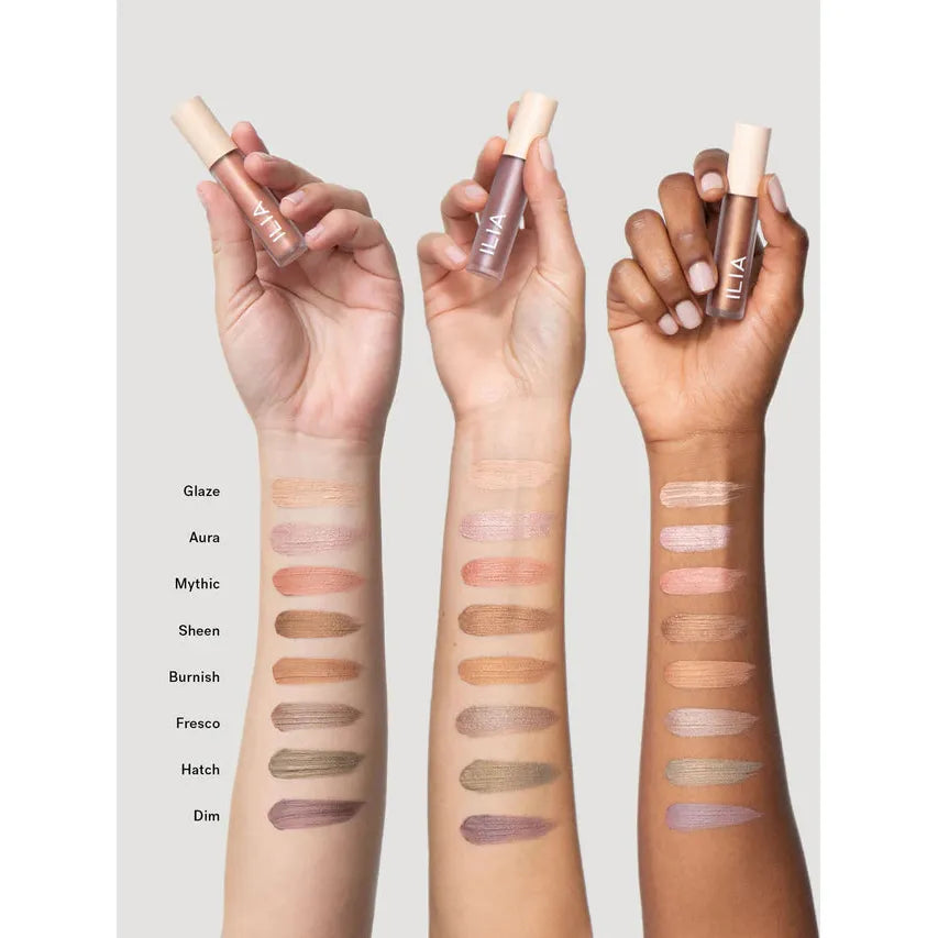 Swatches of various shimmering eyeshadow shades displayed on arms with different skin tones.