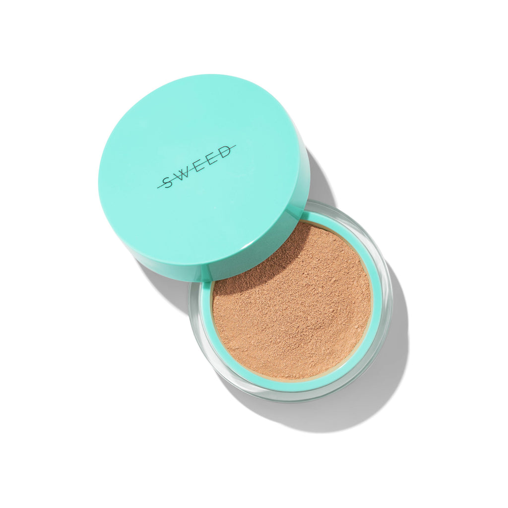A compact cushion foundation with a teal lid, isolated on a white background.