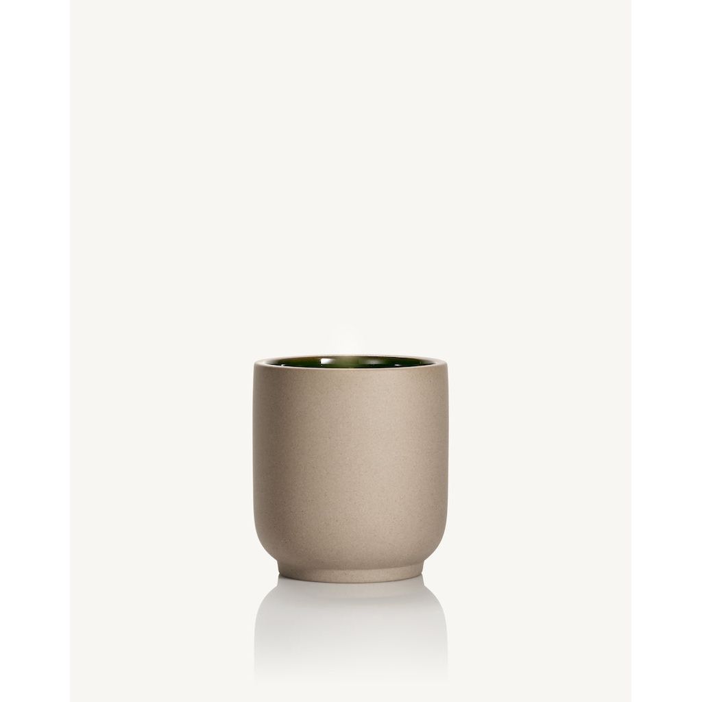 Beige ceramic cup with a glossy interior on a white background.
