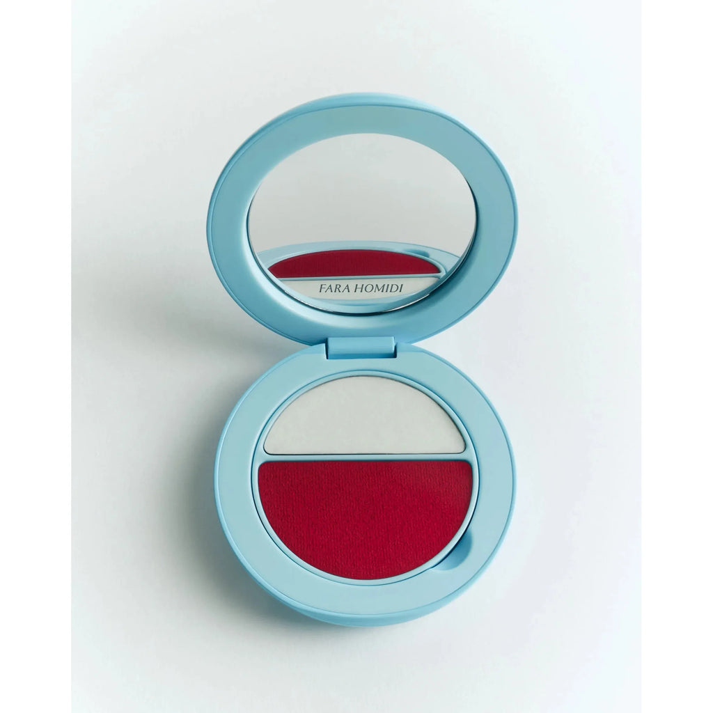 A blue compact with a mirror and two shades of red lip color.