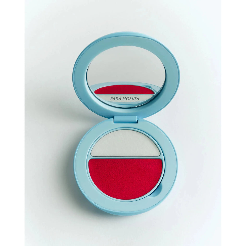 Compact powder makeup case with a mirror and two shades of makeup.