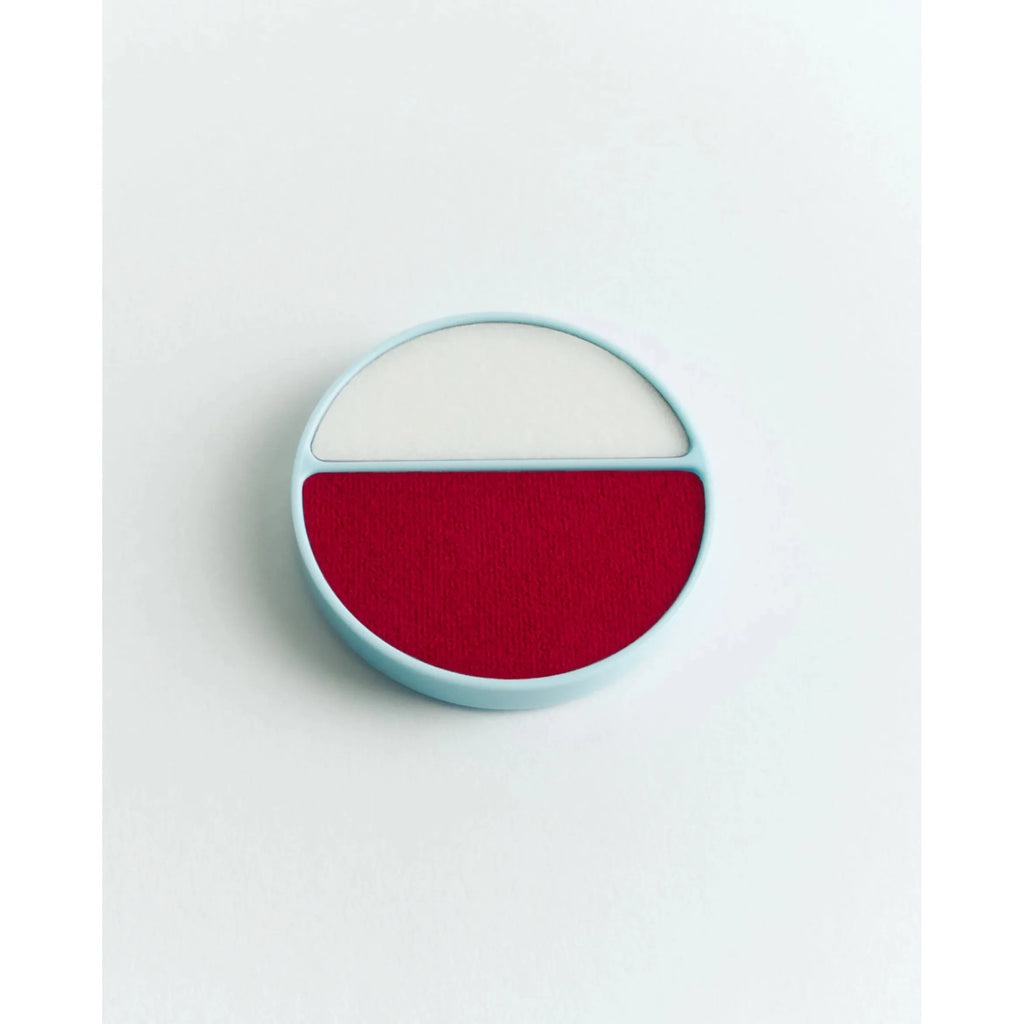 A minimalist, graphic representation of a red semi-circle against a white background within a light blue circle, resembling a stylized flat design.