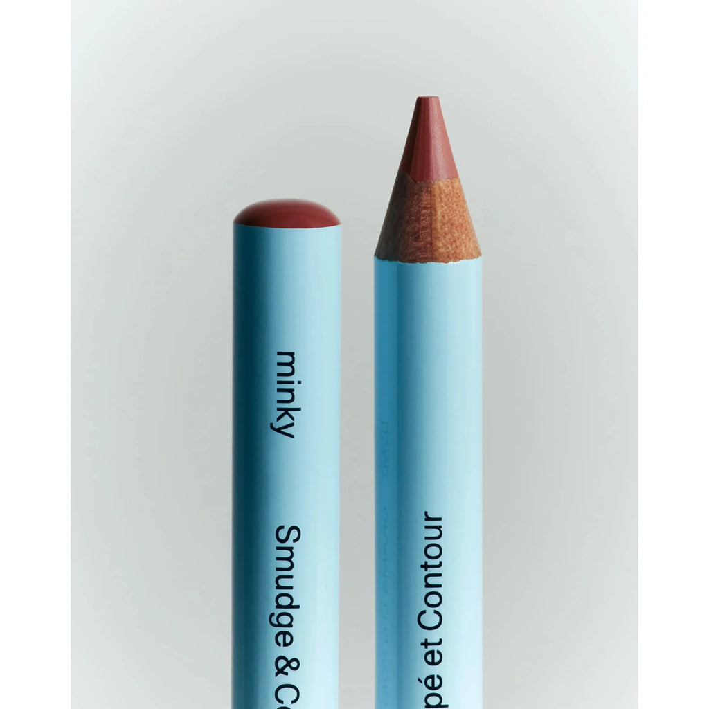 Two blue cosmetic pencils labeled "minky smudge" and "smudge & smoky pet contour" against a white background.