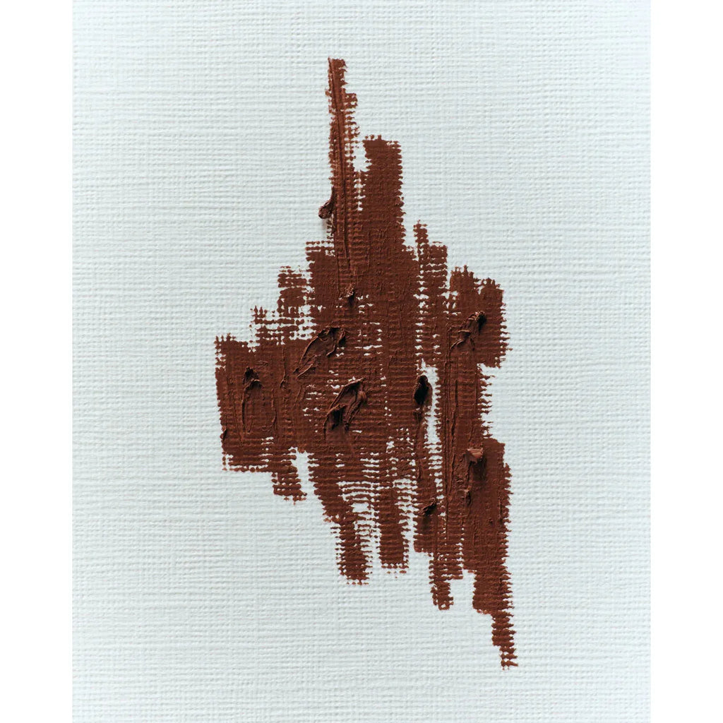 Embroidered brown abstract pattern on a pale fabric background.