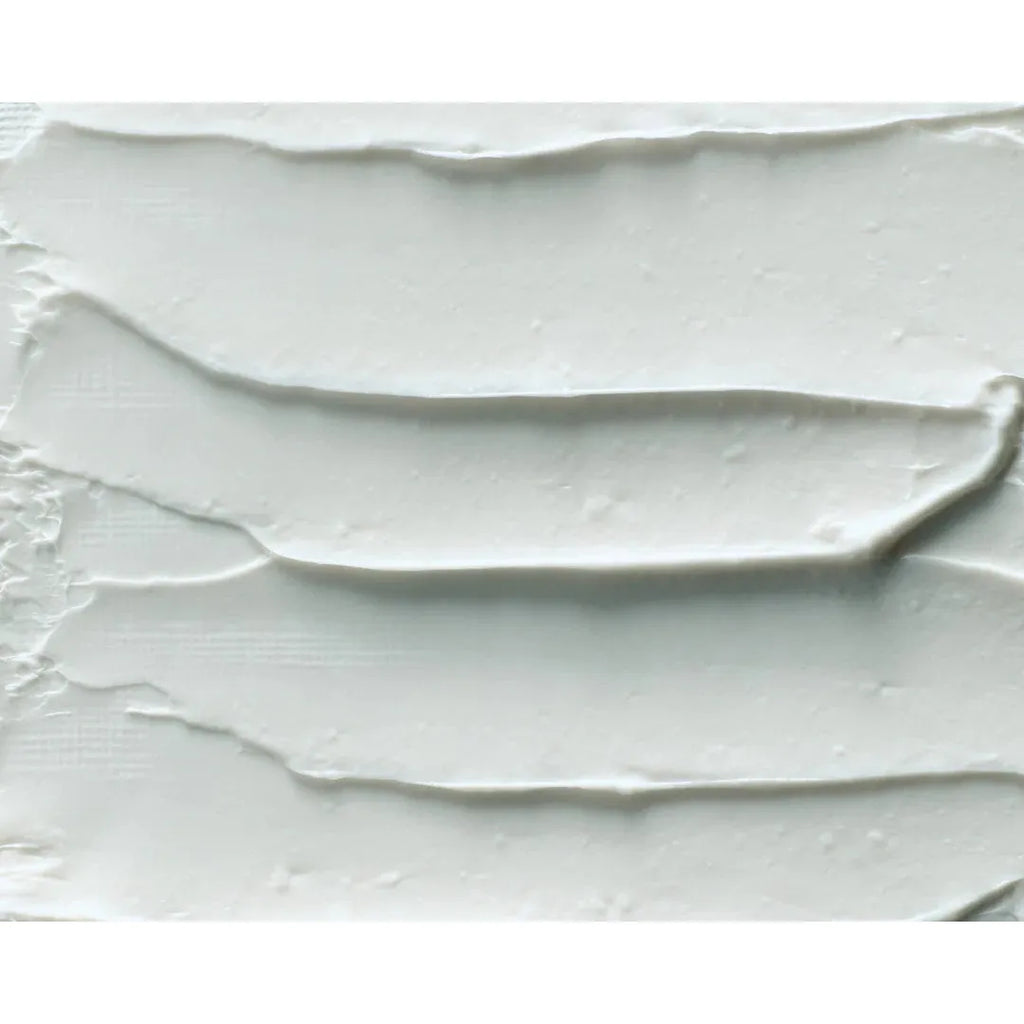 Layers of white cream spread unevenly on a surface.