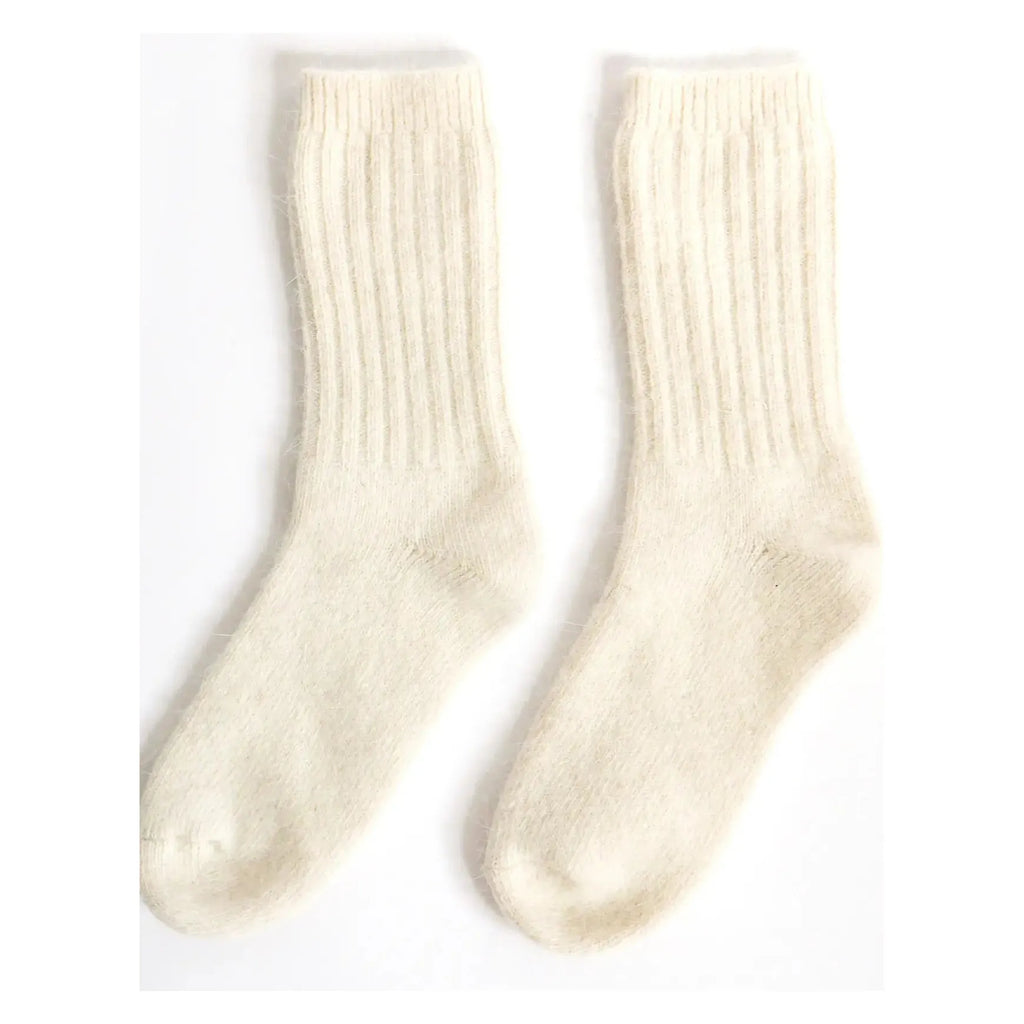 A pair of worn white socks with visible signs of use.