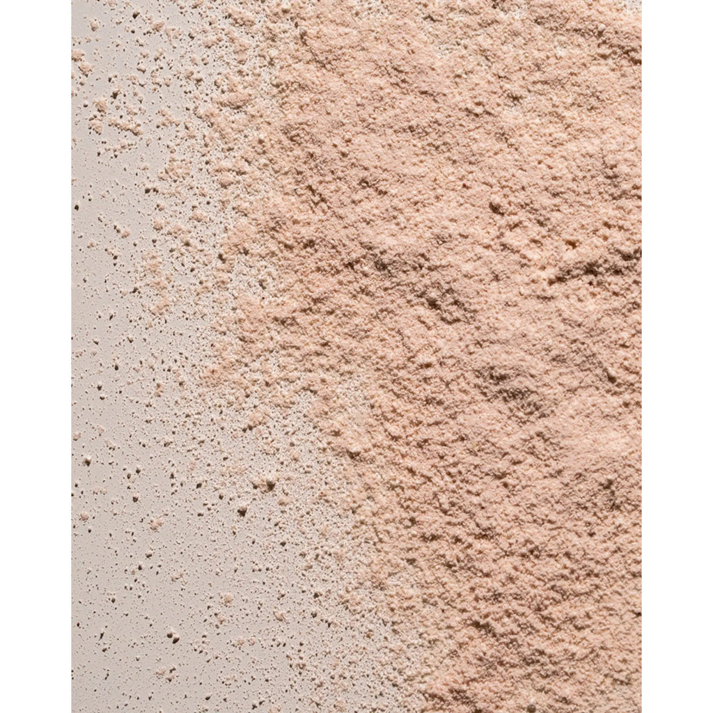 Close-up of a textured powder spread on a surface.
