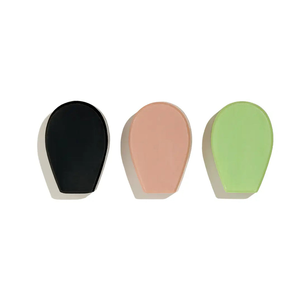 Three colorful makeup sponges arranged side by side on a white background.