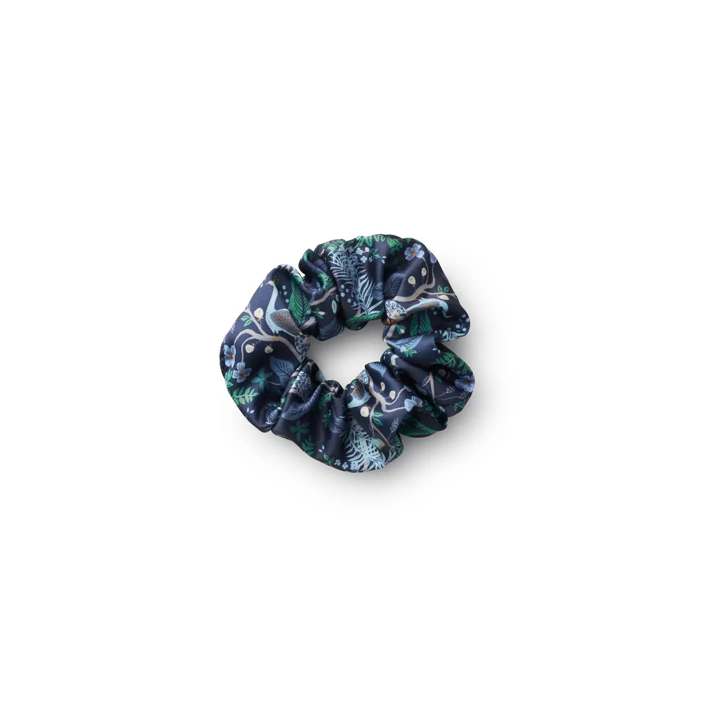 Navy blue scrunchie with a floral pattern on a white background.