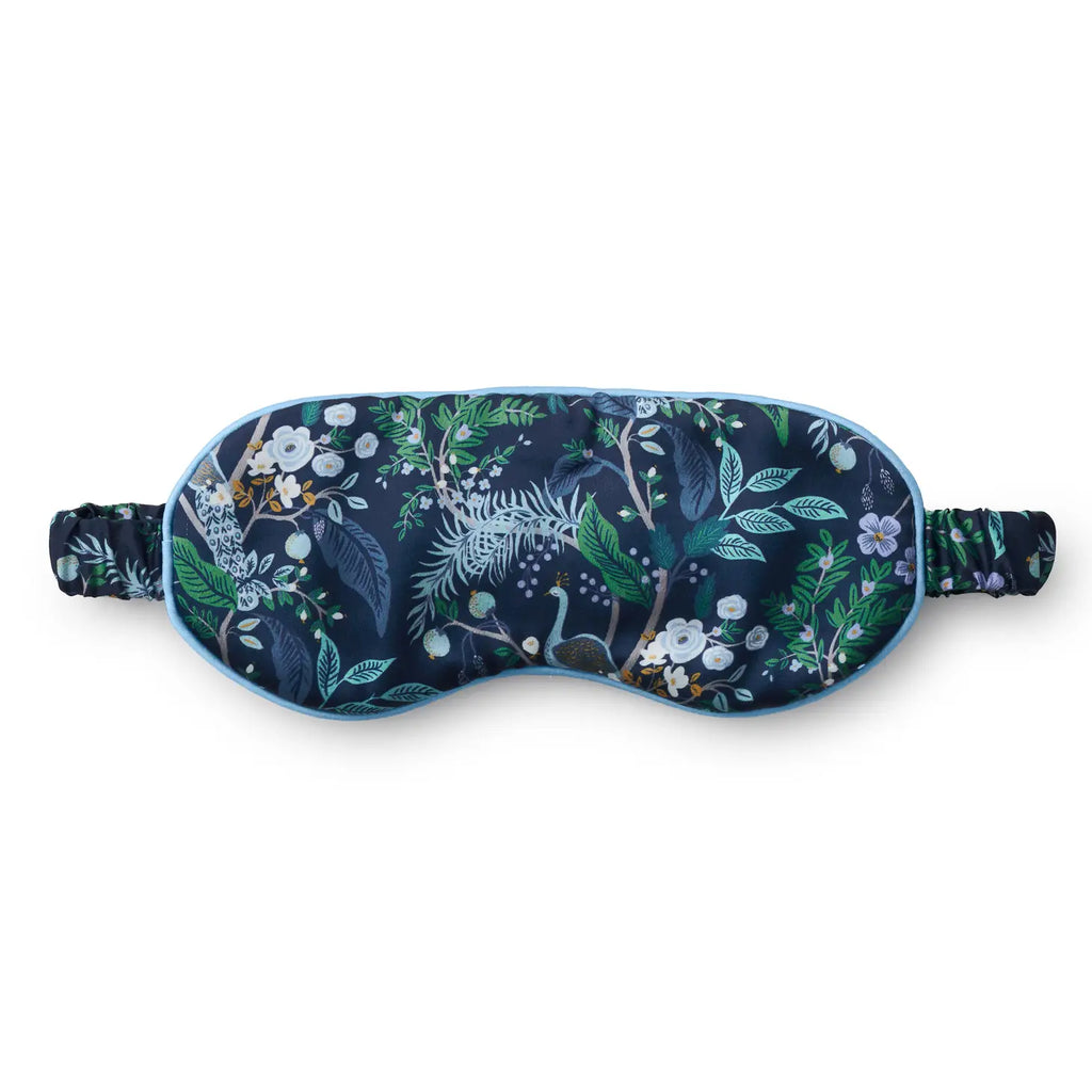 Floral-patterned sleep mask with adjustable strap on a white background.
