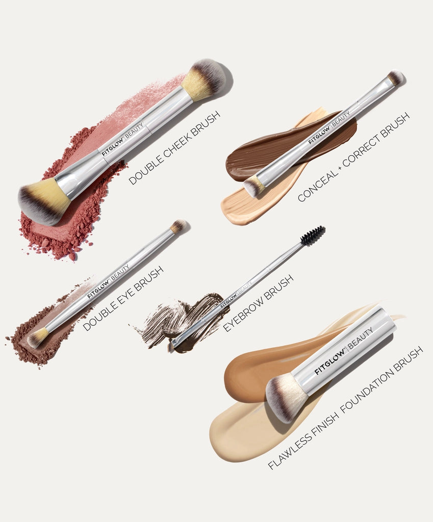 The Fitglow Beauty Master Brush Set, an eco-friendly vegan brush collection, is displayed with cosmetic swatches and features an assortment of makeup brushes including the Double Cheek Brush, Conceal + Correct Brush, Double Eye Brush, Eyebrow Brush, and Flawless Finish Foundation Brush.