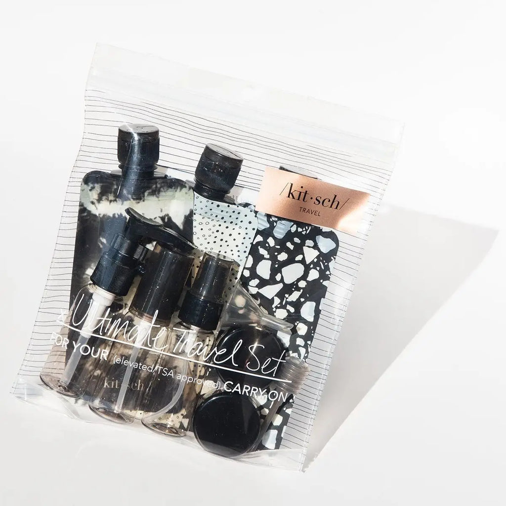A travel-sized toiletry set with various containers in a clear, zippered pouch.