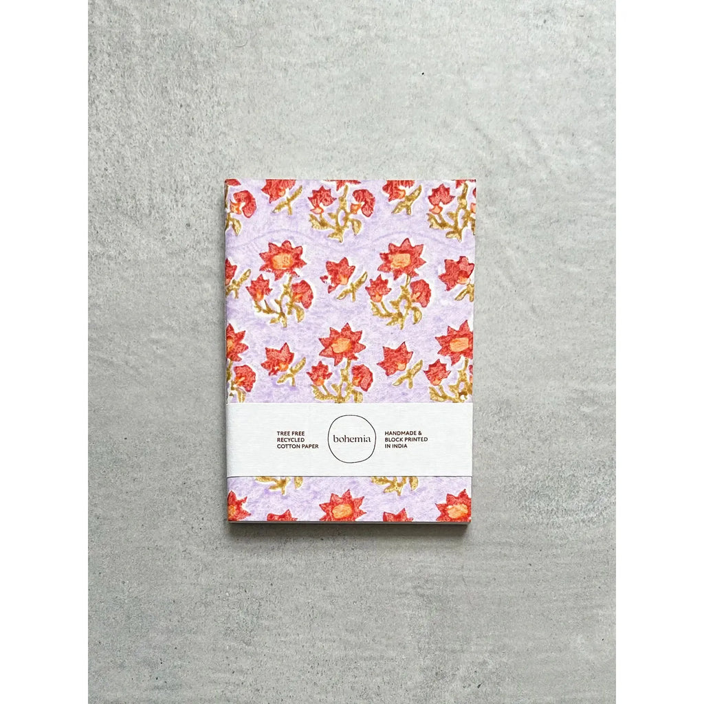 A notebook with a floral pattern cover and a label indicating it is a medium-sized, lined, bohemia-style notebook.