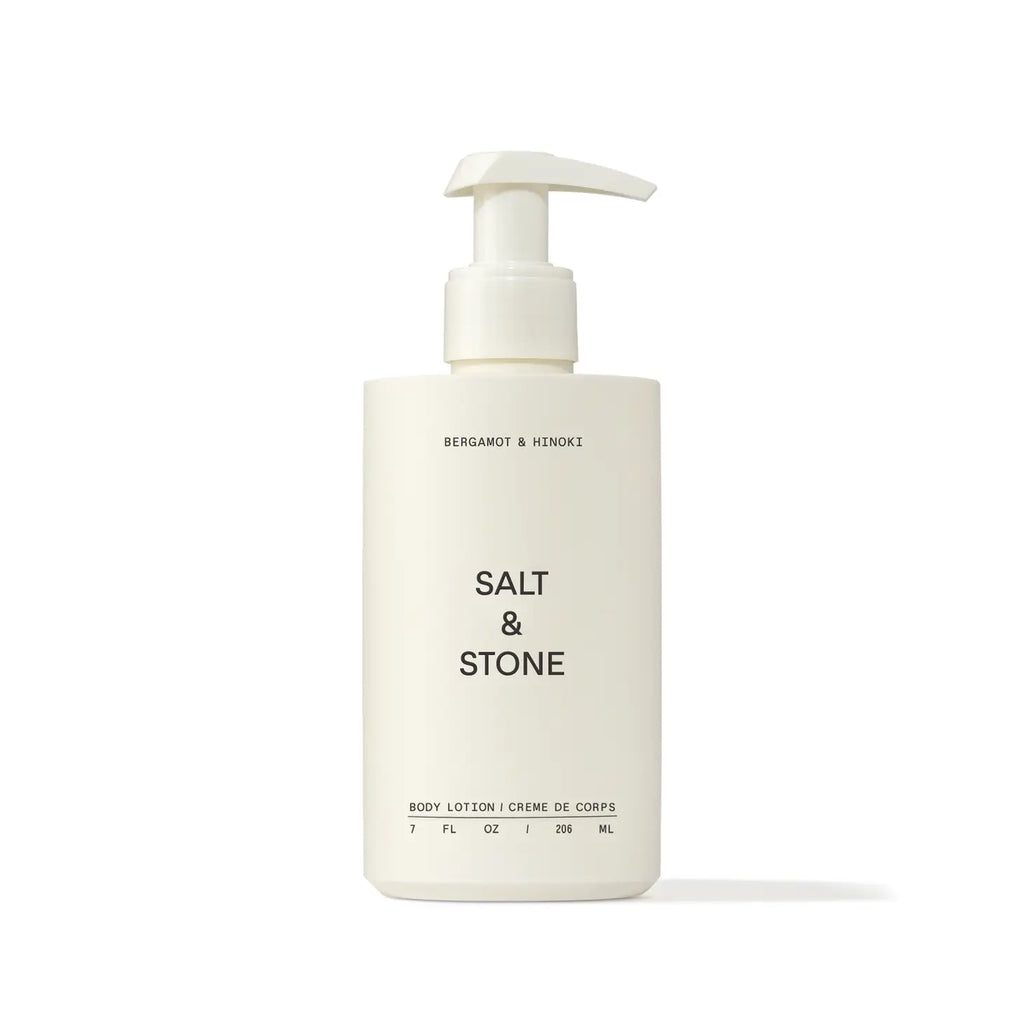 A bottle of salt & stone body lotion with a pump dispenser against a white background.