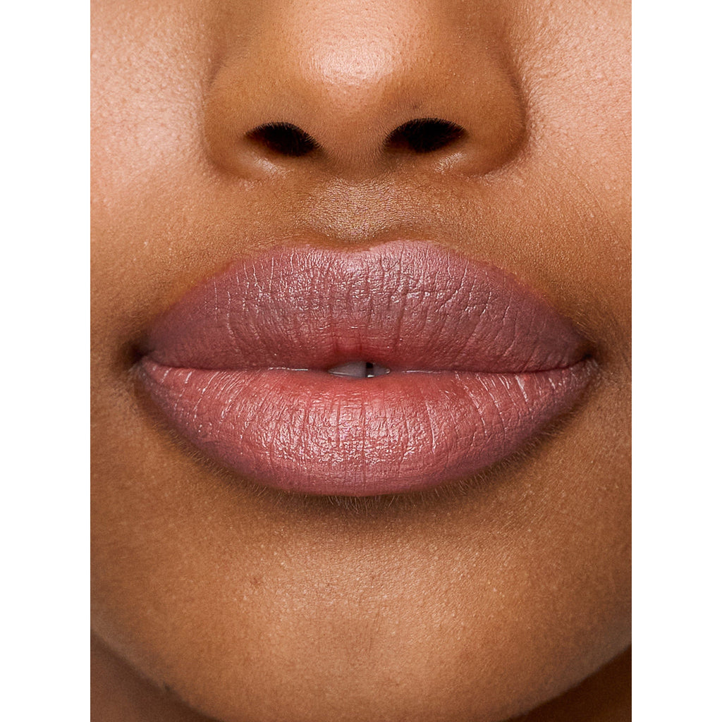 Close-up of a person's lips with pink lipstick.