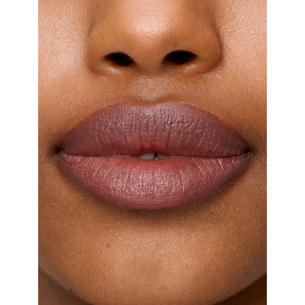 Close-up of a person's lips with matte lipstick.