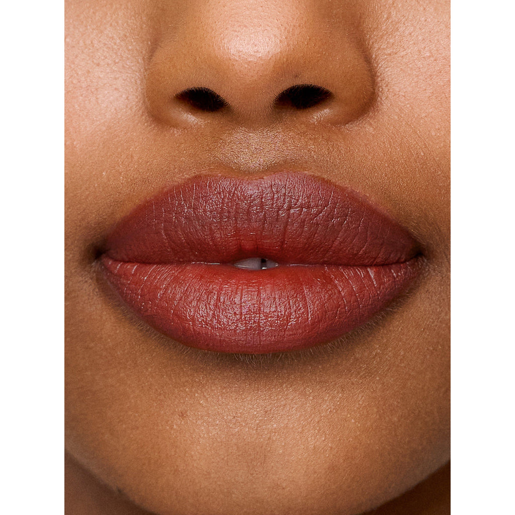 Close-up of a person's lips with red lipstick.