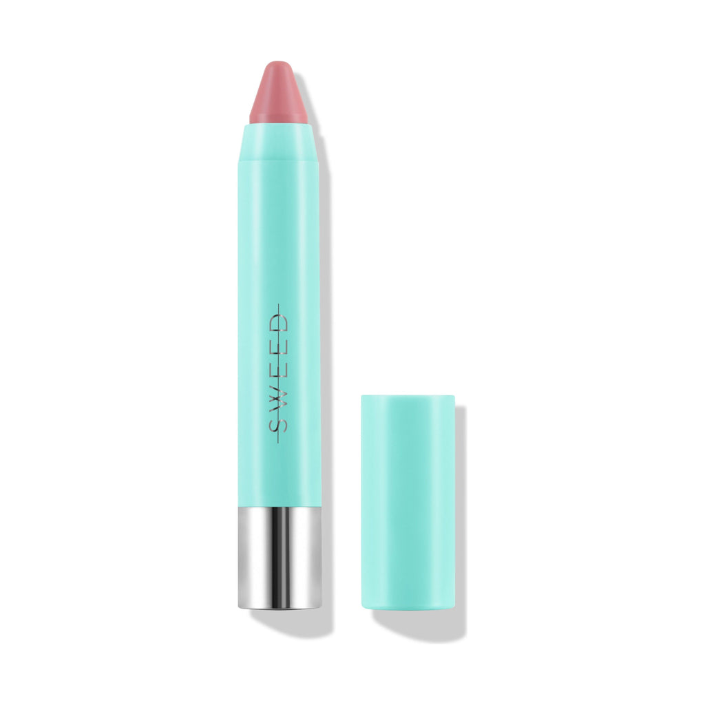 A lip crayon with its cap removed, showcasing a nude shade.