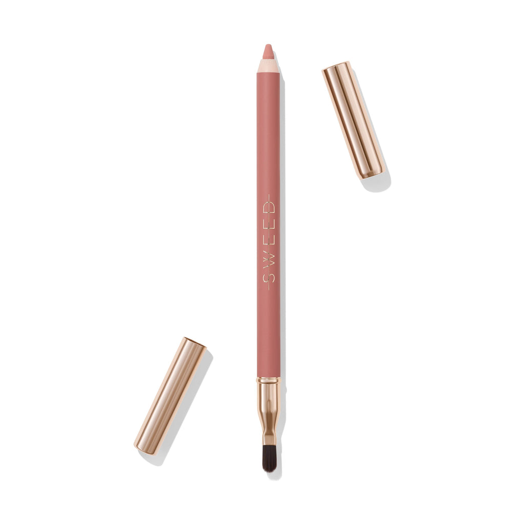A nude lip liner pencil with a brush on one end and a cap off to the side.